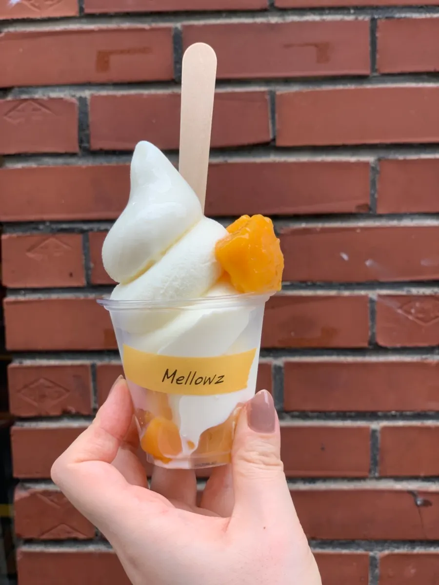 Half-eaten cup of mango ice cream
