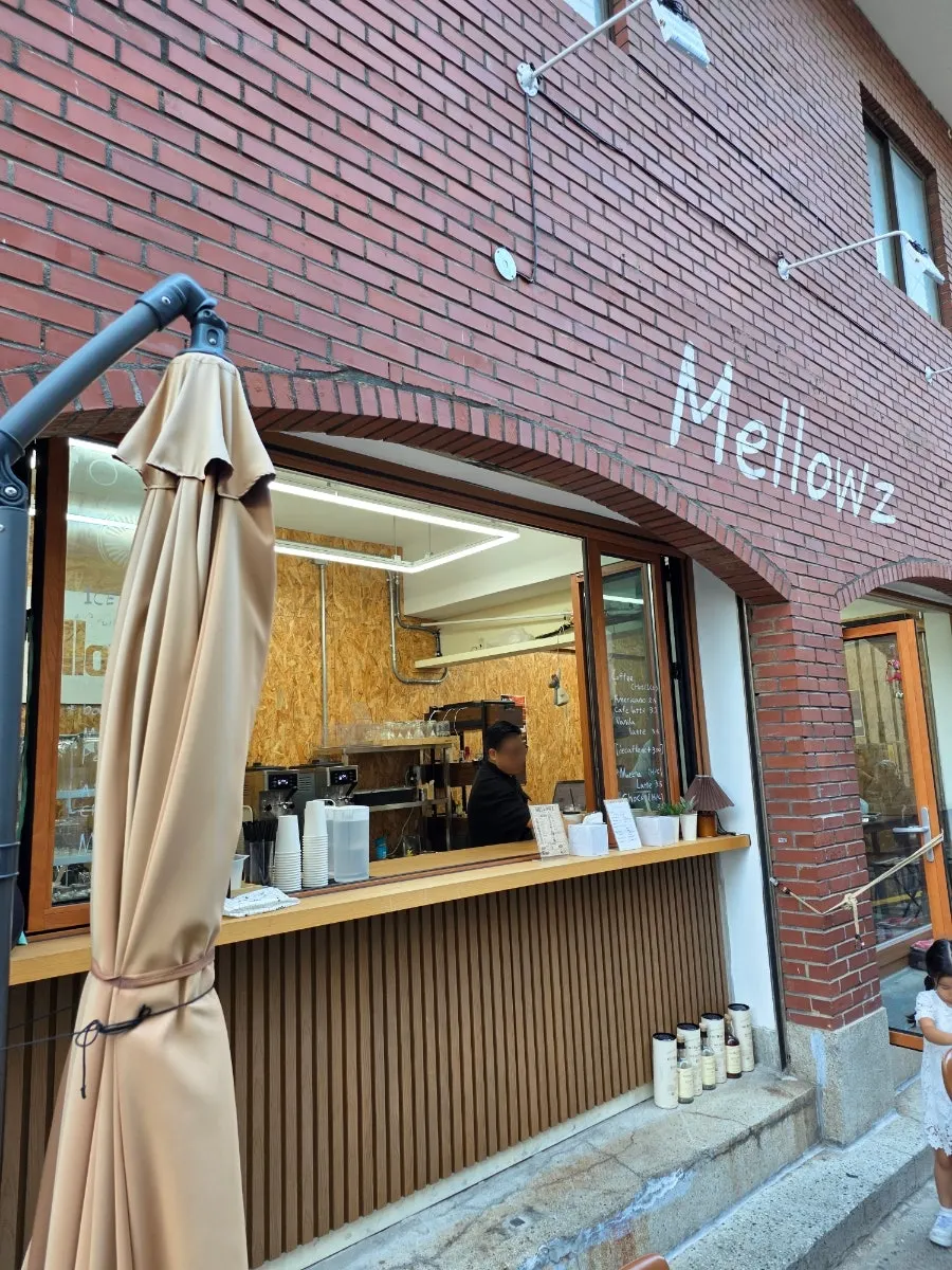 Red-brick wall near Mellows' entrance