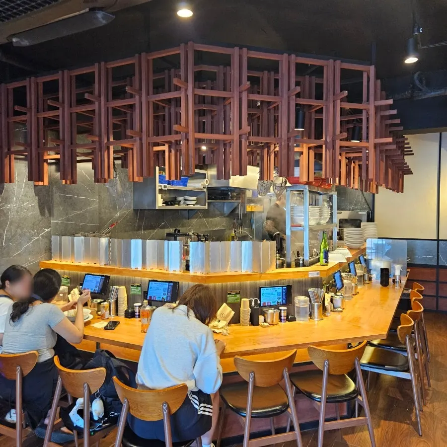 Mentsuru's open kitchen running along the bar table