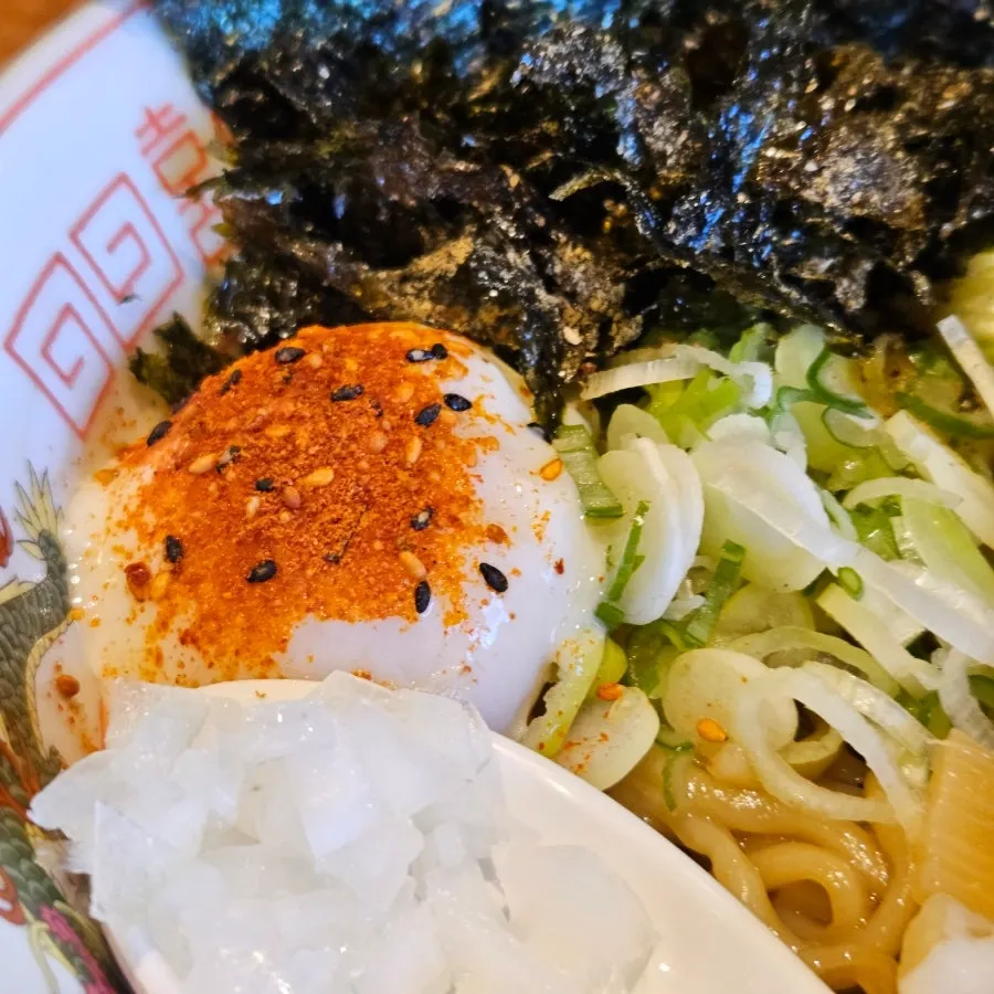 Half-boiled egg yolk on top of the abura soba