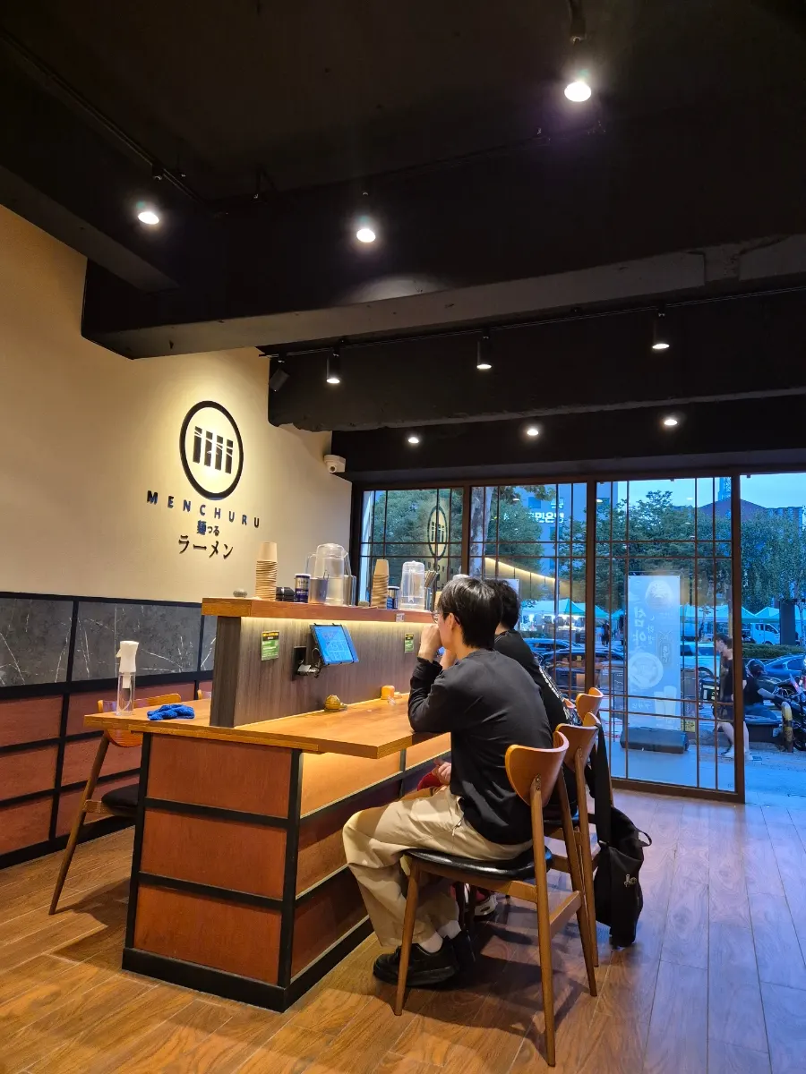 Entrance of the ramen shop with wood frames and glass windows