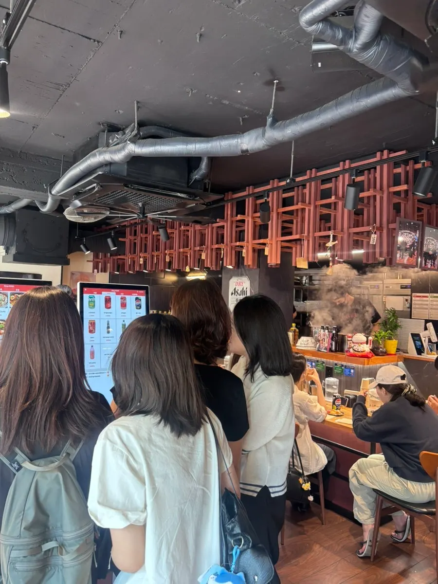 Basement seating at Mentsuru City Hall Branch with many solo diners