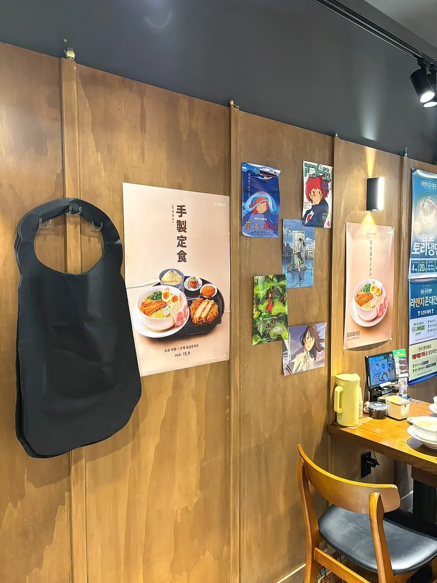 Menji menu board listing yakitori and rice bowls