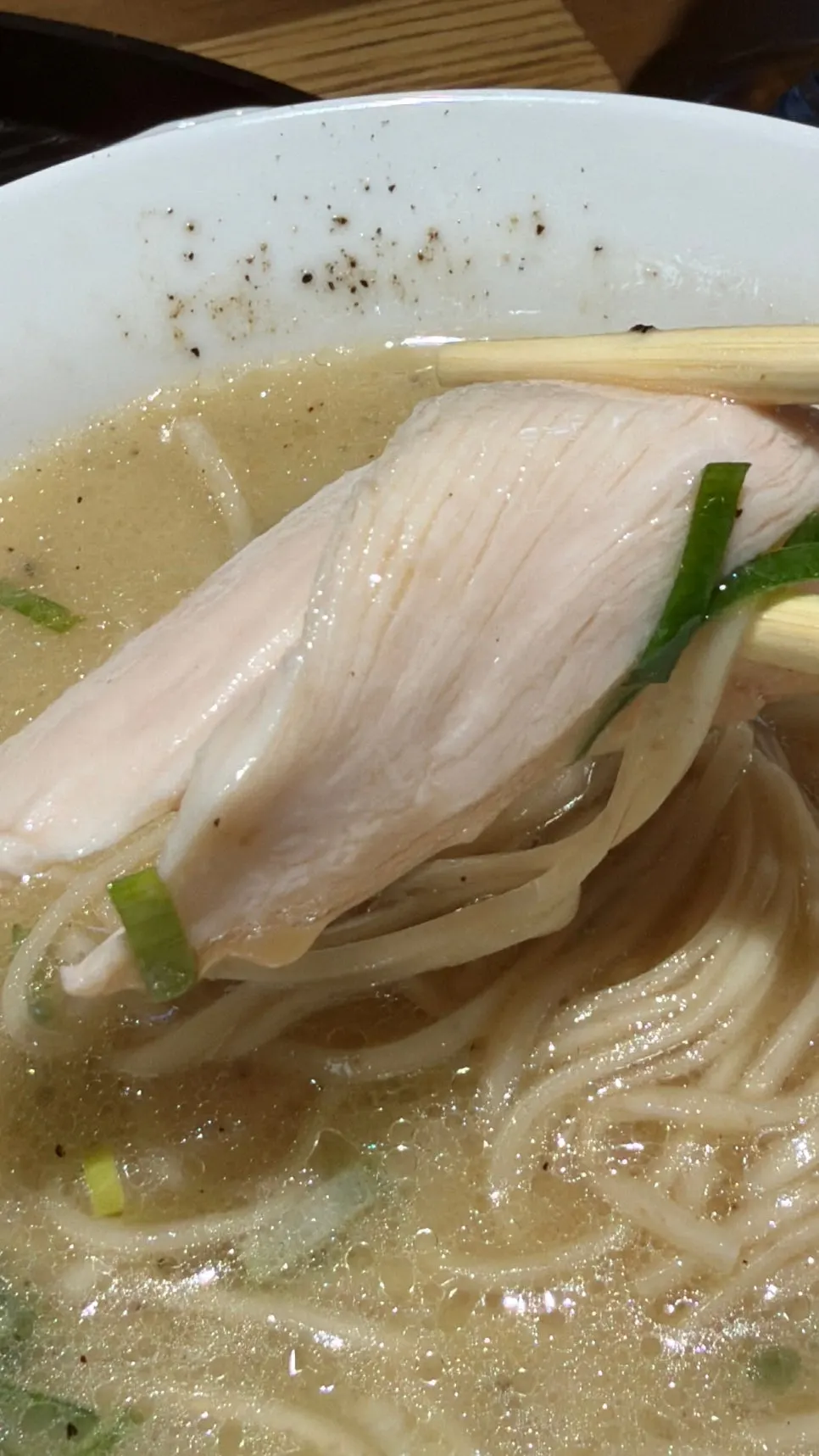 Tender chicken with visible grain and chewy fresh noodles