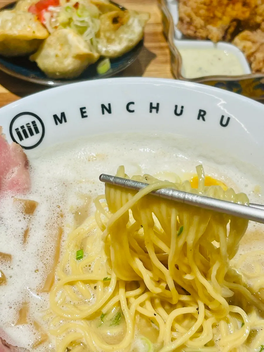Ramen noodles lifted with chopsticks