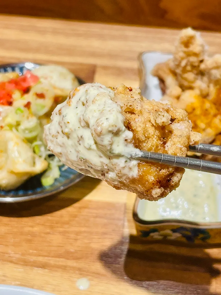 Dipping karaage into sauce
