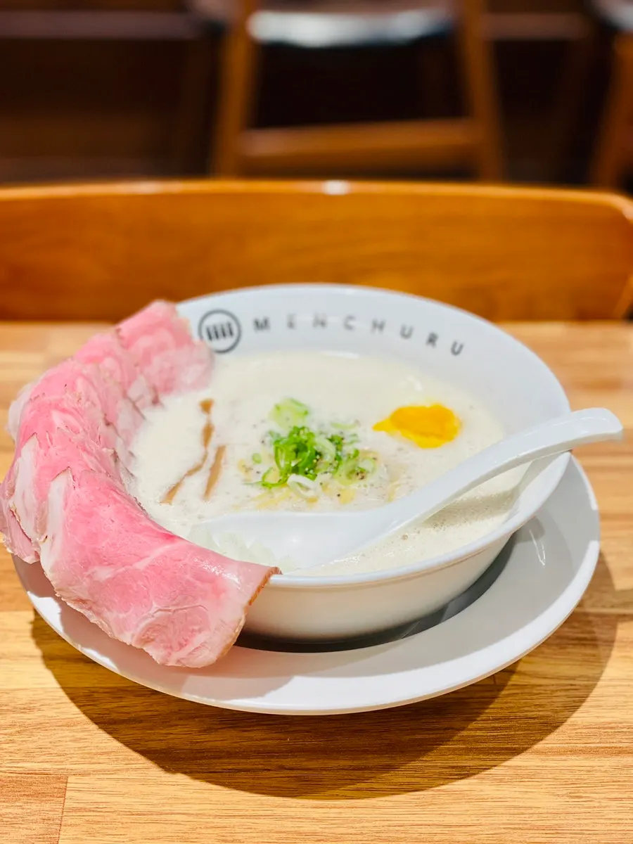 A solo dining table set with ramen and side dishes