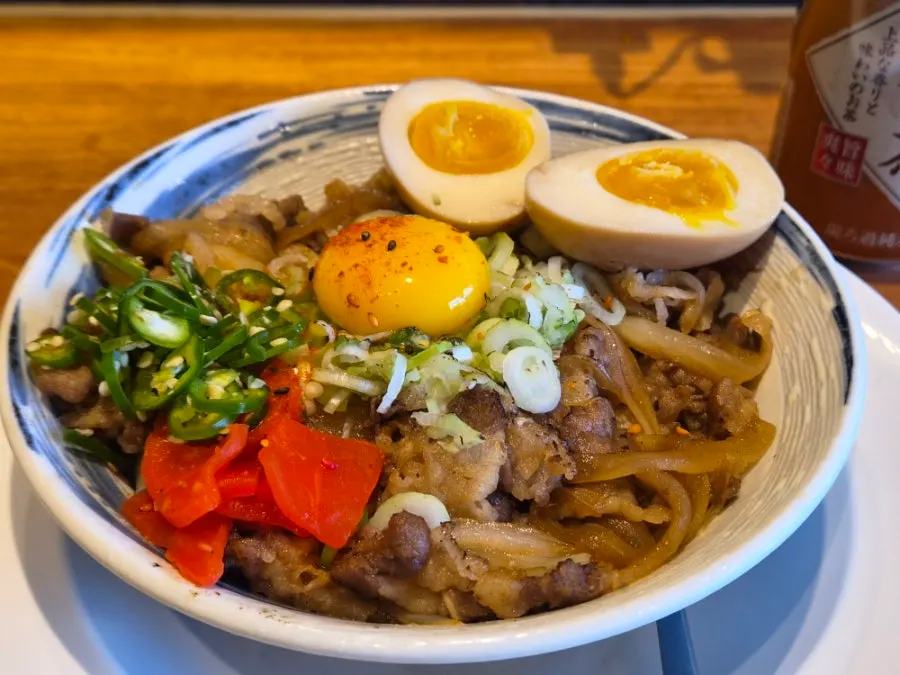 Soft-boiled egg yolk on top of gyudon
