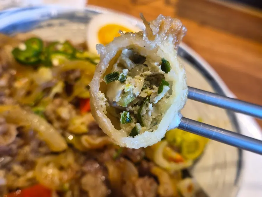 Fried gyoza dipped in soy sauce