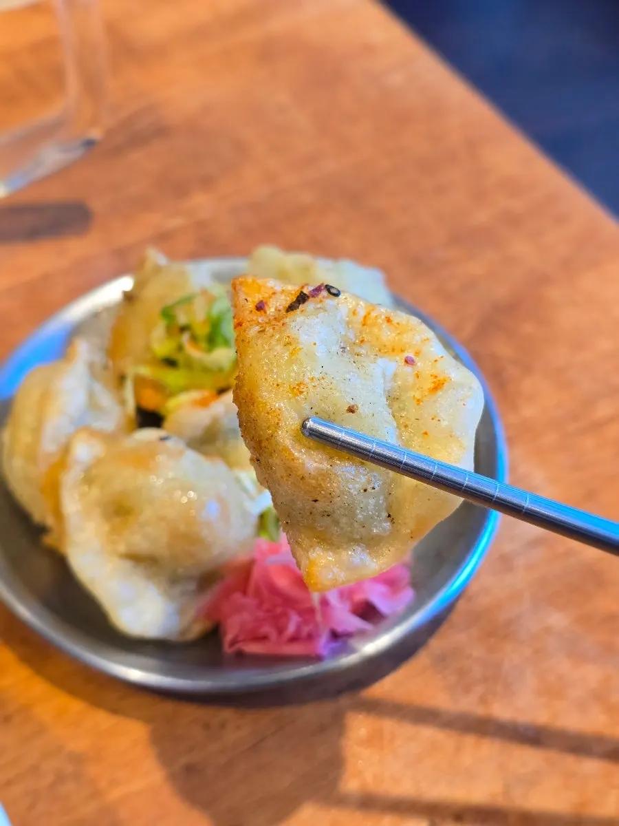Fried gyoza eaten with pickled ginger