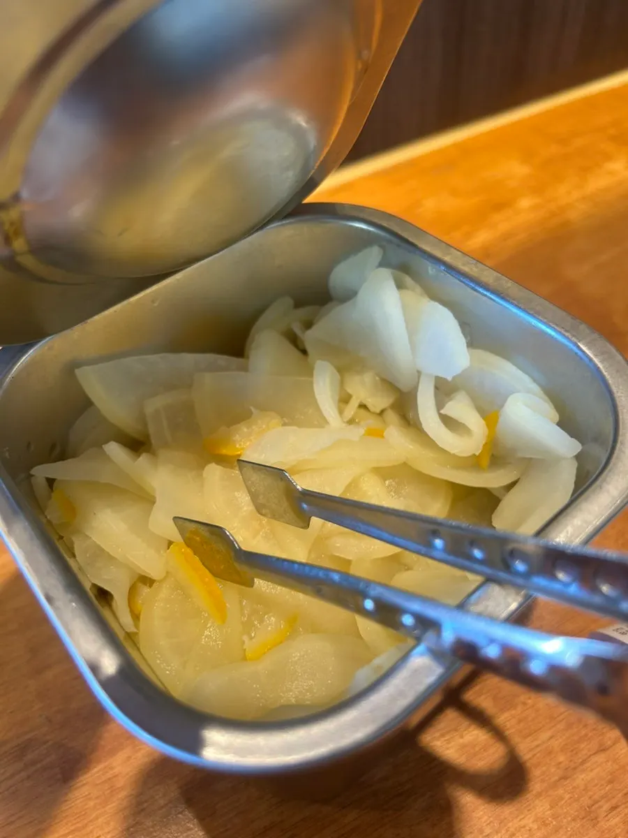 Mentsuru's yuzu pickled radish served with tongs