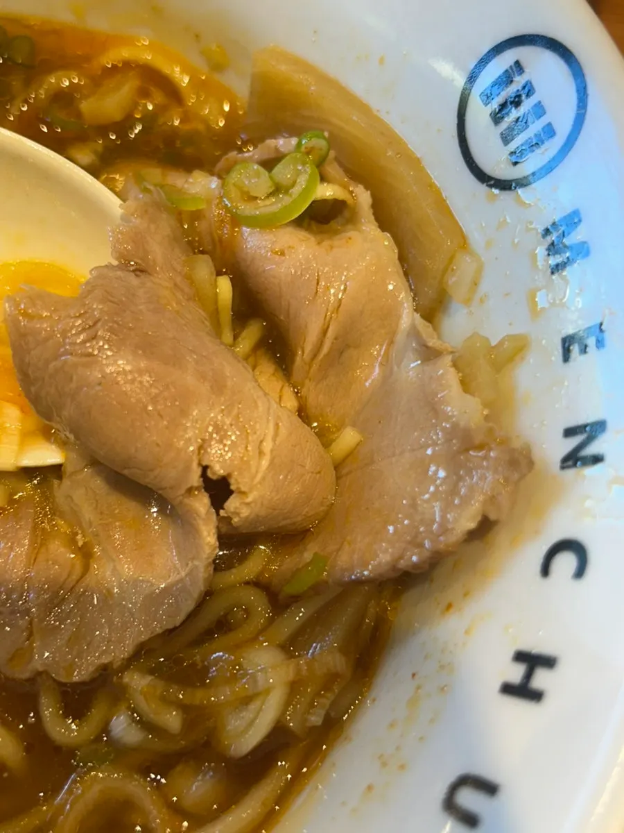 Close-up of thick chashu in the spicy shoyu ramen broth