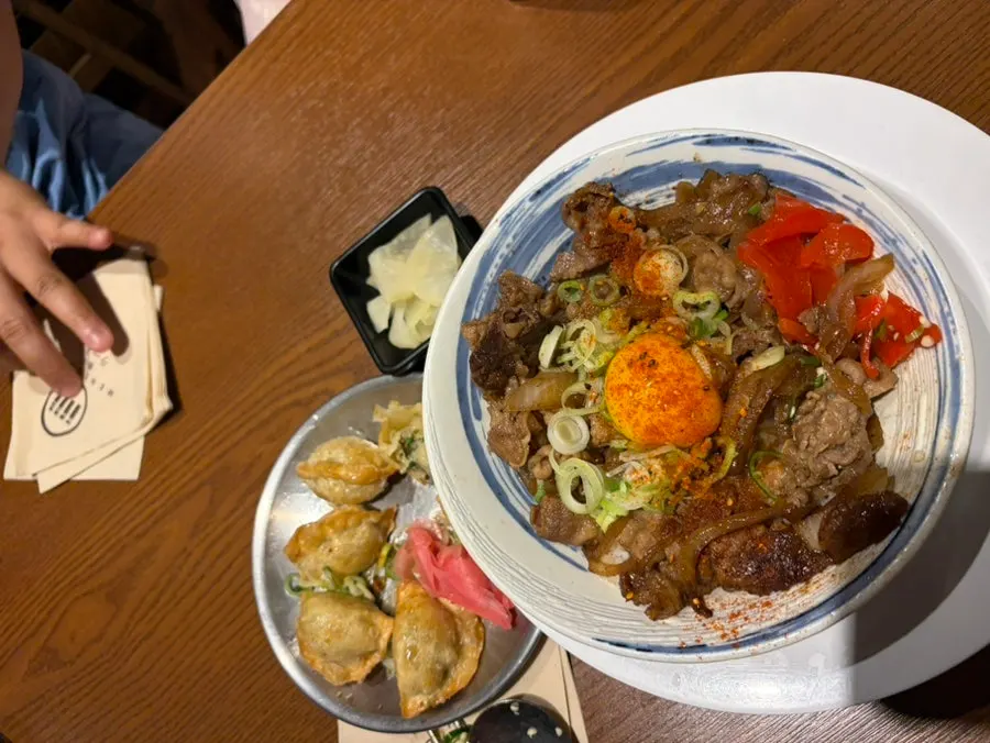 Table setting with gyoza alongside the rice bowls
