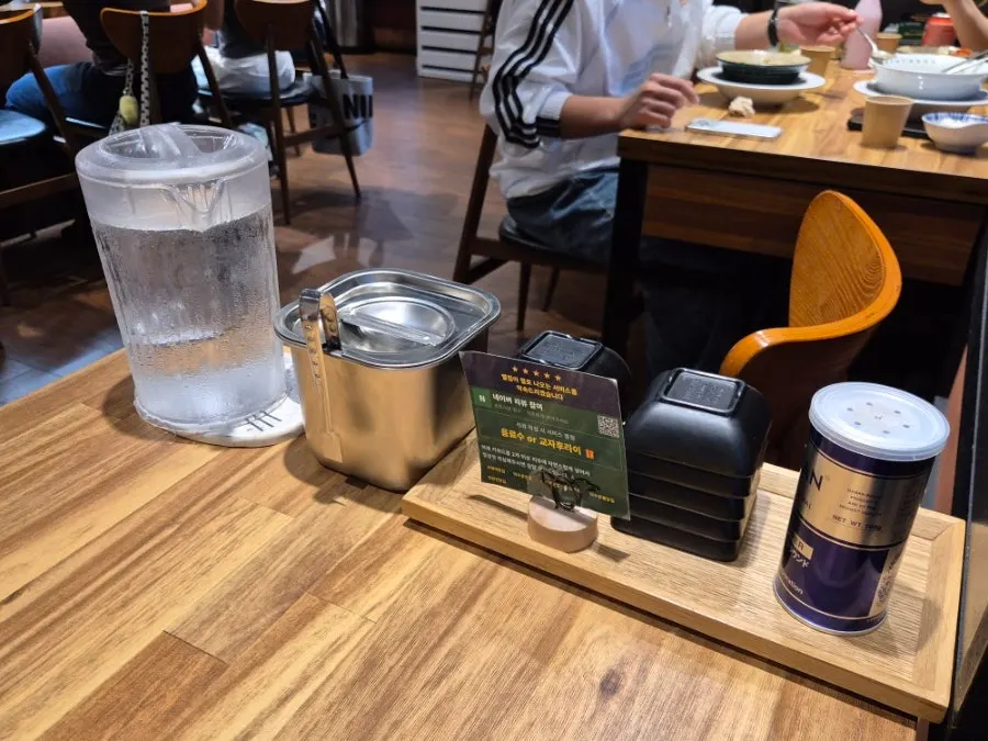 Table setting with bowl, water, and pickled radish