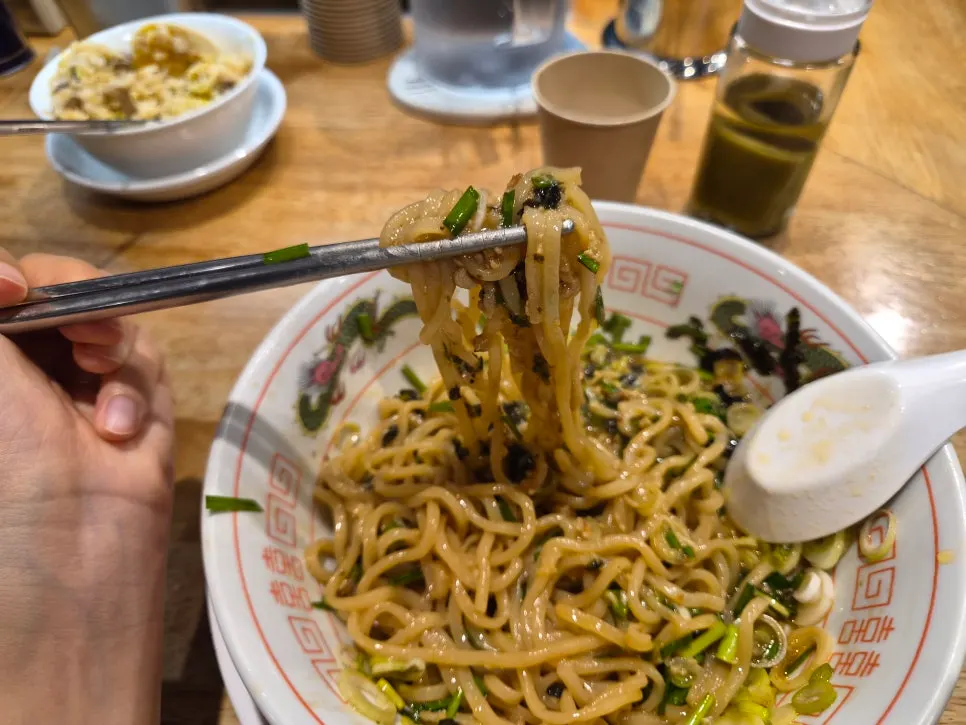 Mentsuru mazesoba topped with egg yolk and meat