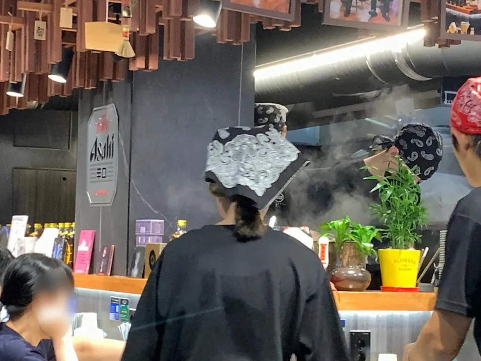 Ramen restaurant seating full of customers during dinner hours