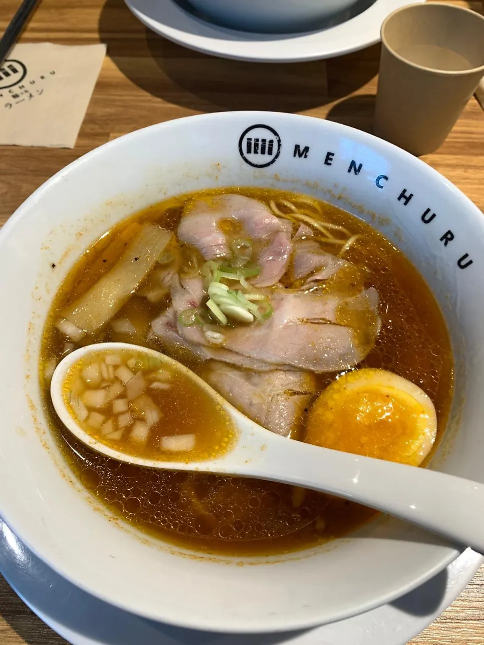 Close-up of ramen topped with chashu and a soft-boiled egg