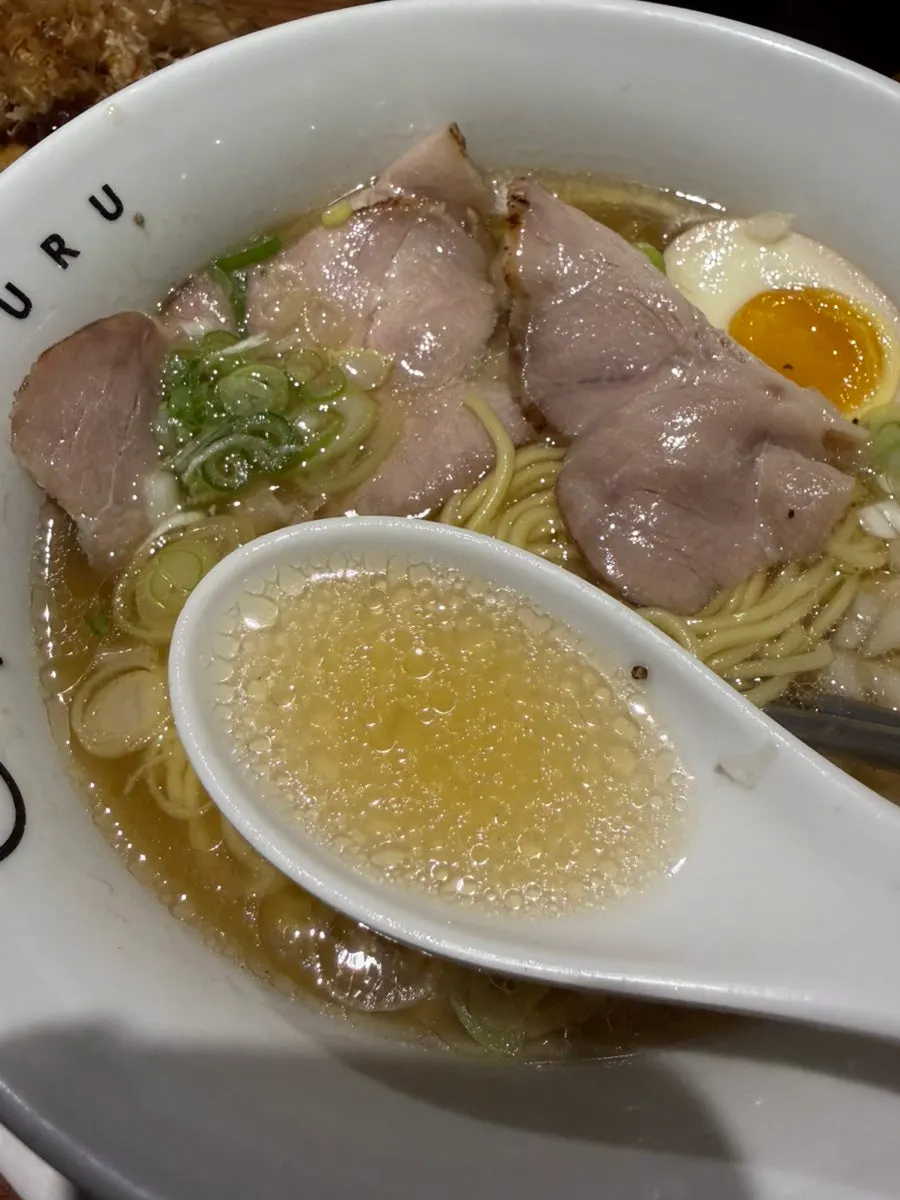 Noodles lifted up from the shio ramen bowl