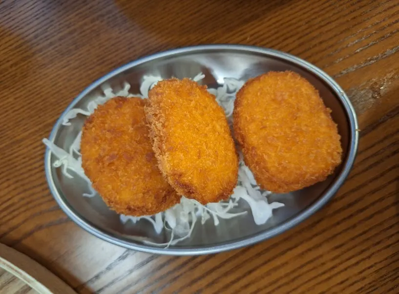 A plate of three croquette pieces
