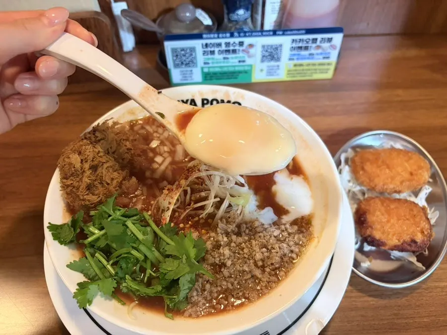 Close-up of rich tomato broth and beef katsu