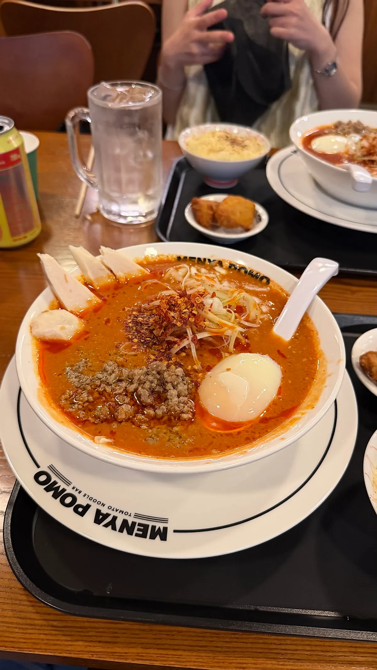 A bowl of tantan tomato ramen topped with chicken breast