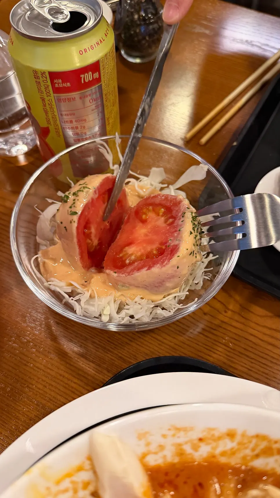 Tomato salad plate with shredded cabbage underneath