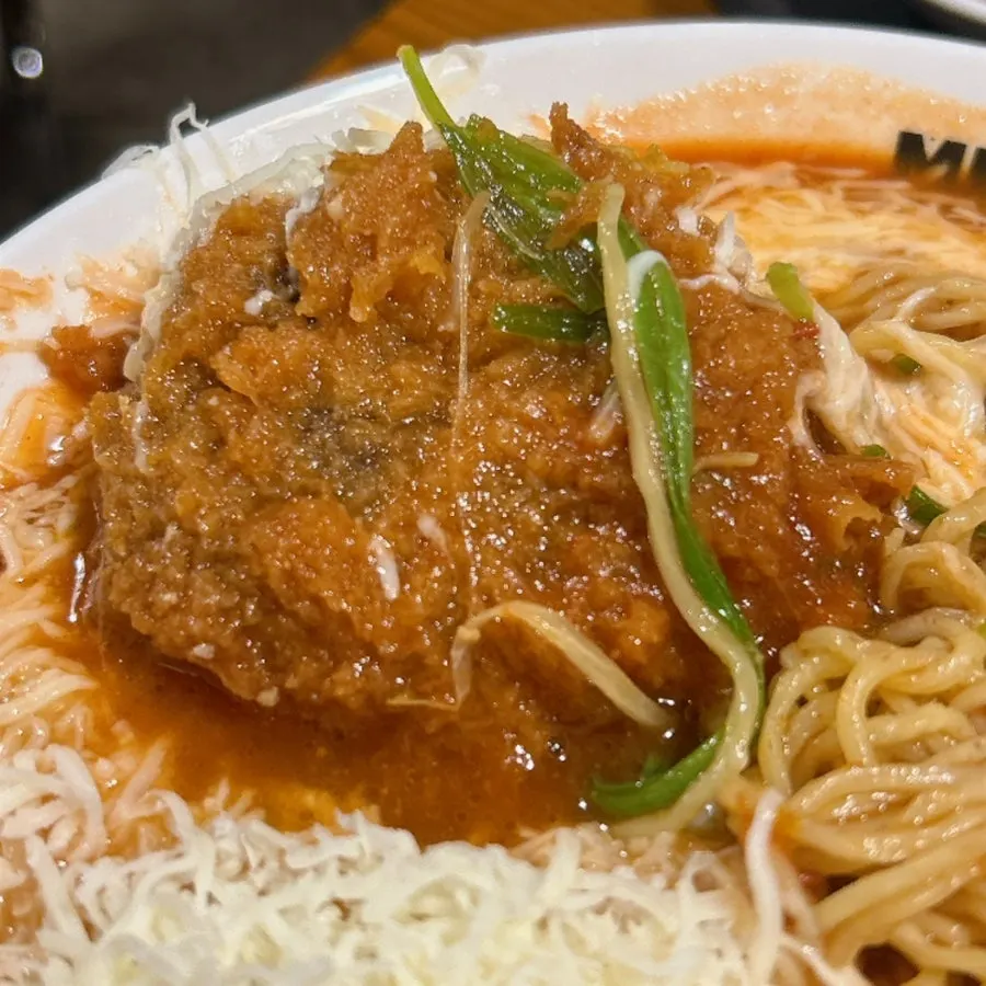 Cheese topping melting into the tomato broth