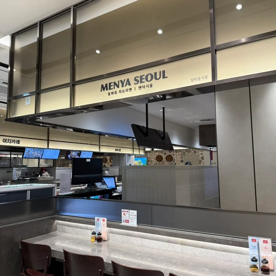 Interior of Menya Seoul arranged around bar-style tables