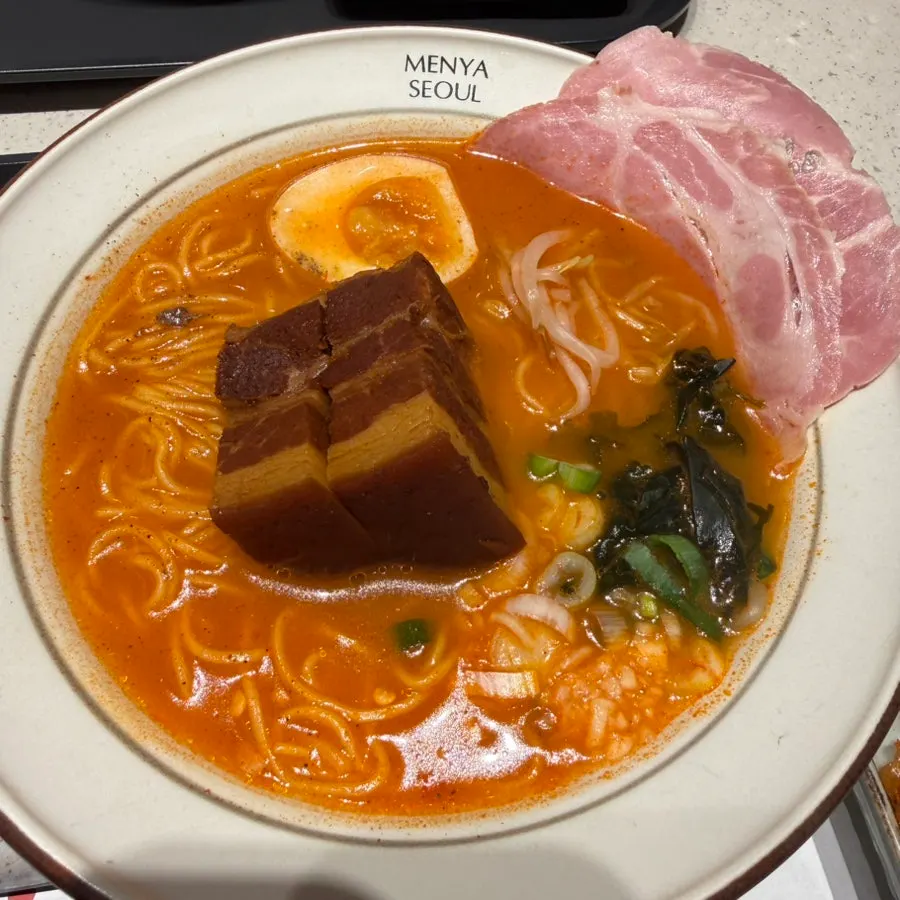 Two bowls of dongpo pork ramen sets on the table