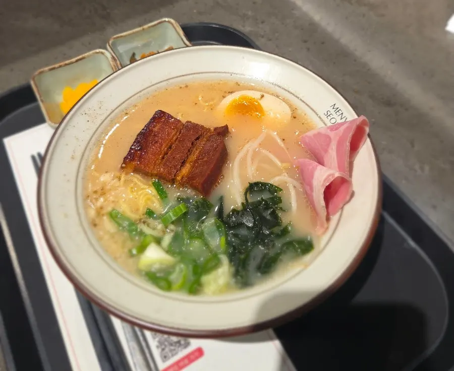 A bowl of Menya Seoul char siu ramen topped with thick char siu