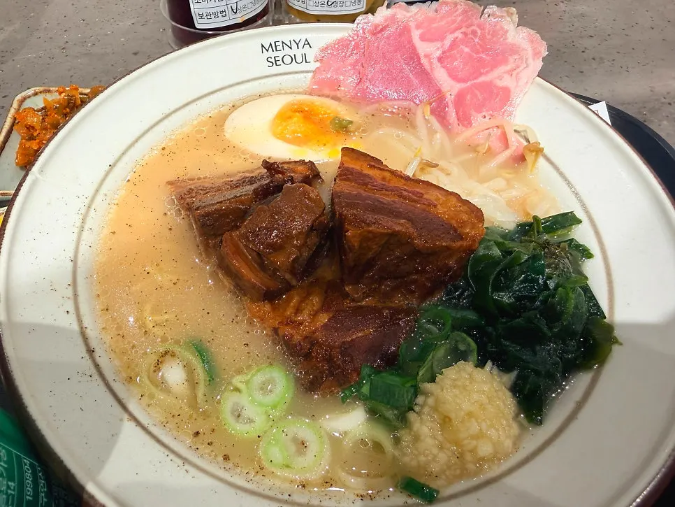 Bowl of dongpo pork ramen topped with jambon