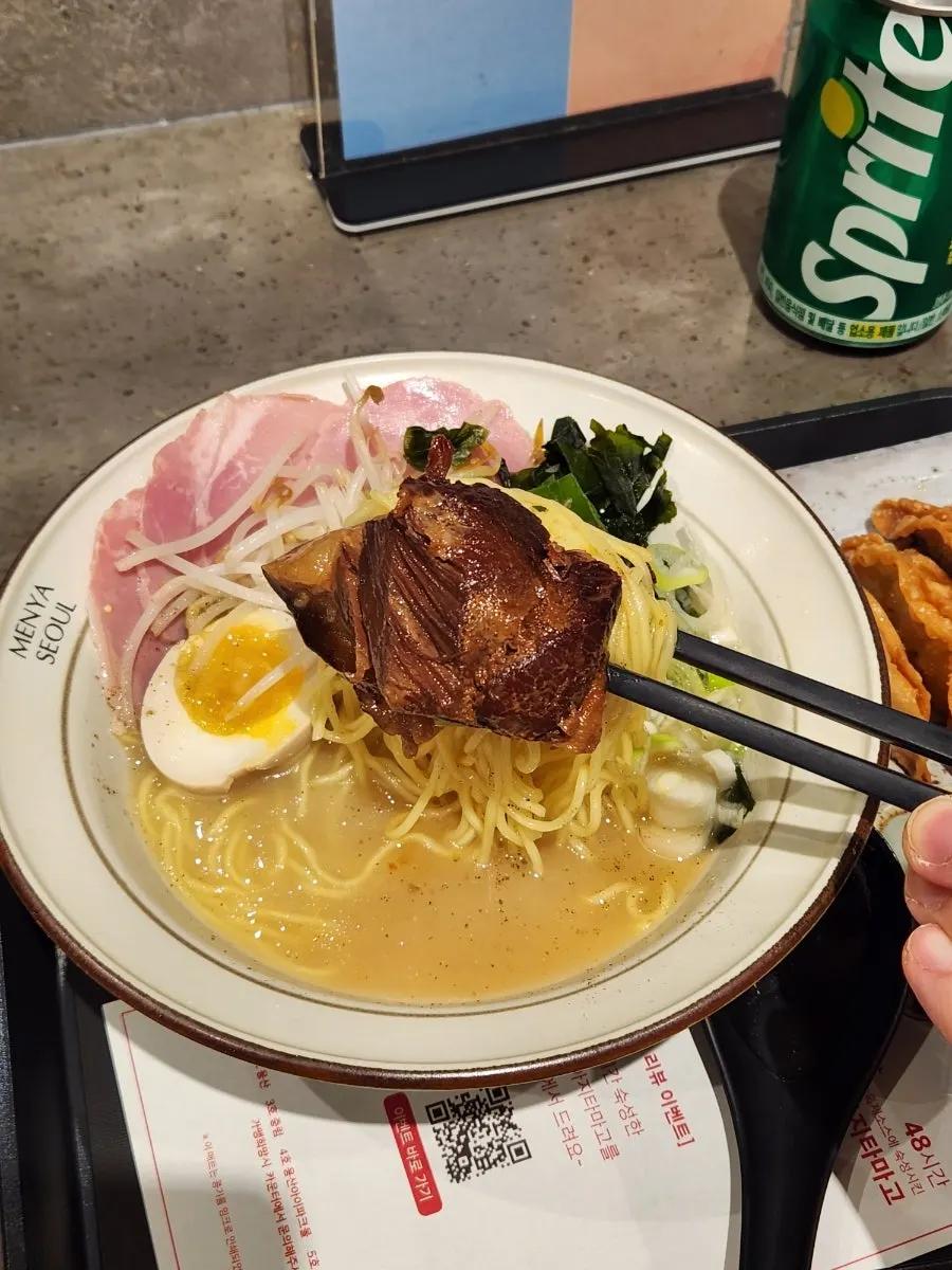 Thin noodles lifted from the mild broth dongpo pork ramen
