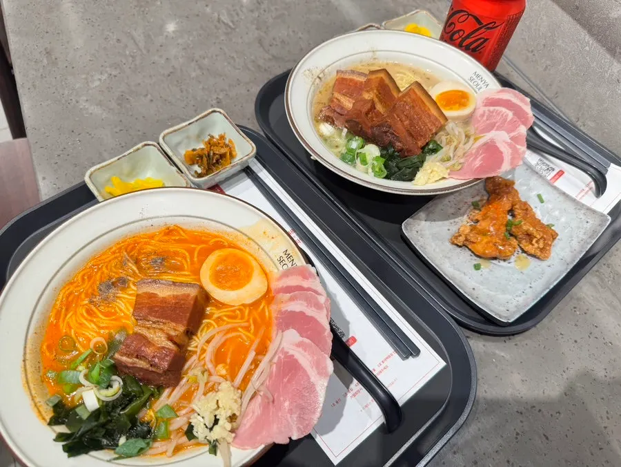 Table set with two bowls of dongpo pork char siu ramen