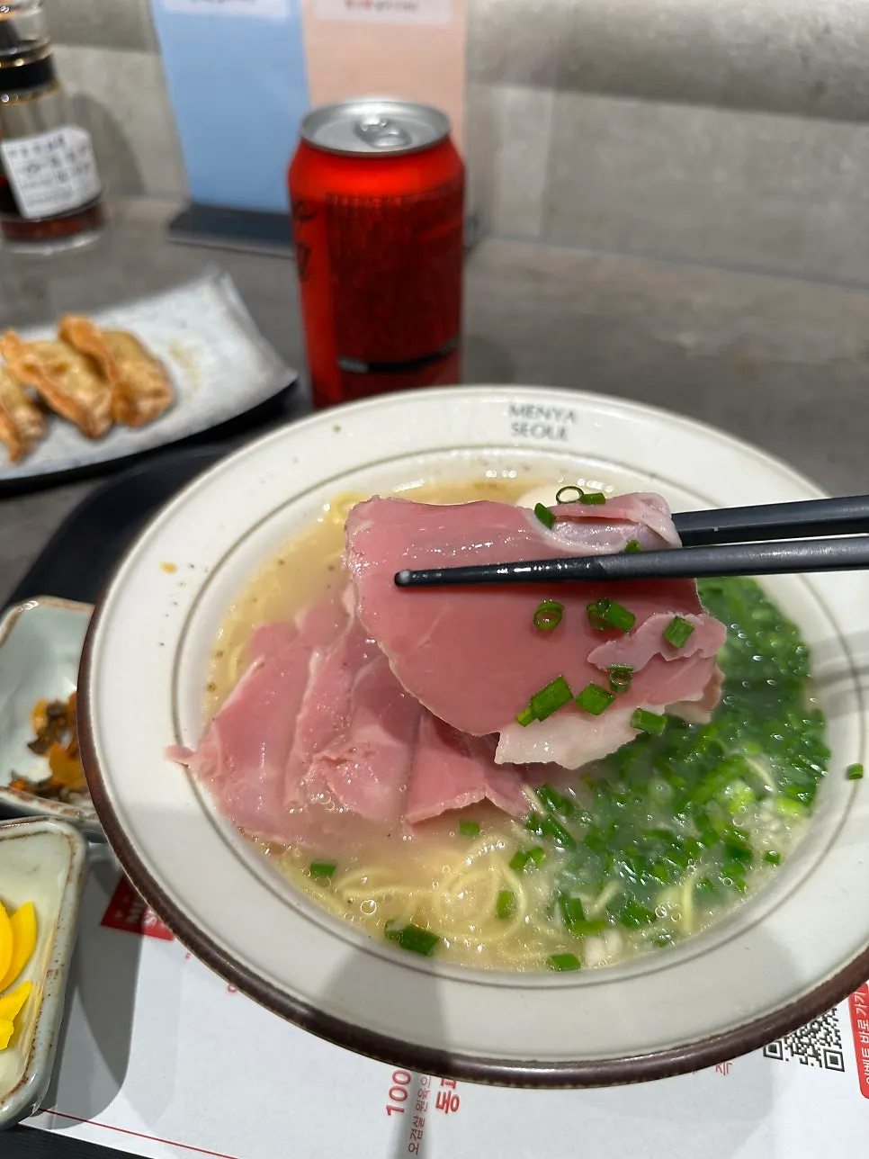 Lifting a piece of jambon ham with chopsticks