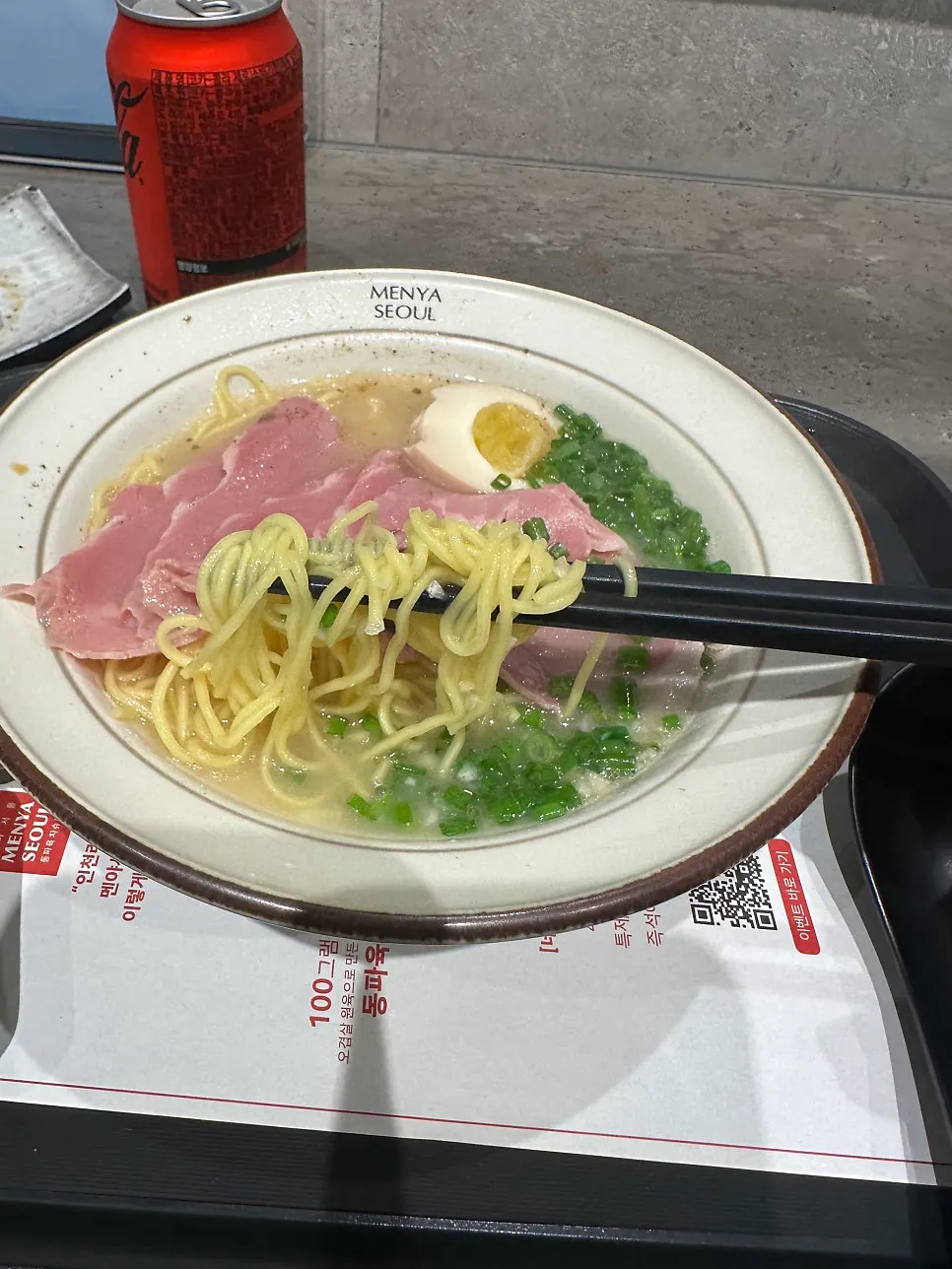 A piece of jambon dipped in tonkotsu broth