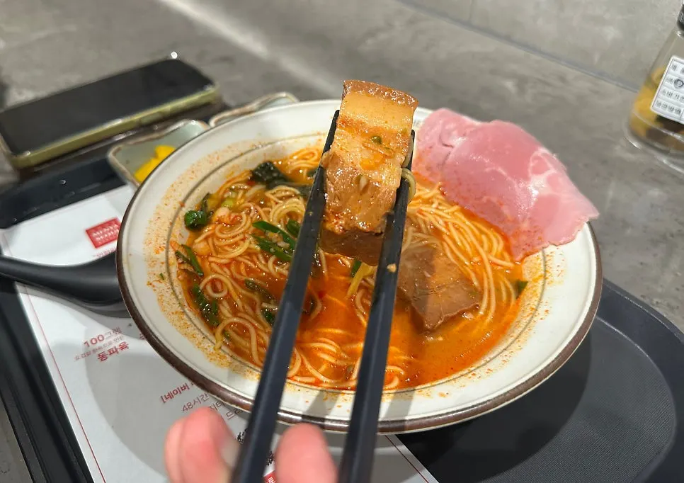 Two nearly finished bowls of ramen on the bar table