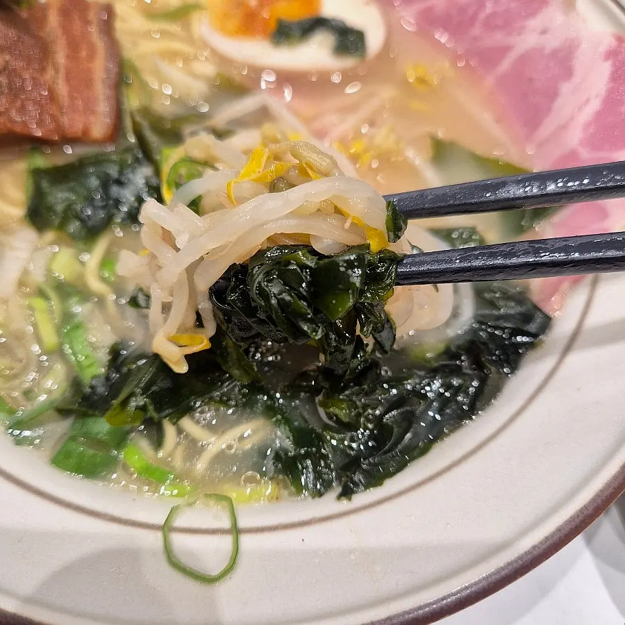 Close-up of ramen topped with dongpo pork and jambon char siu