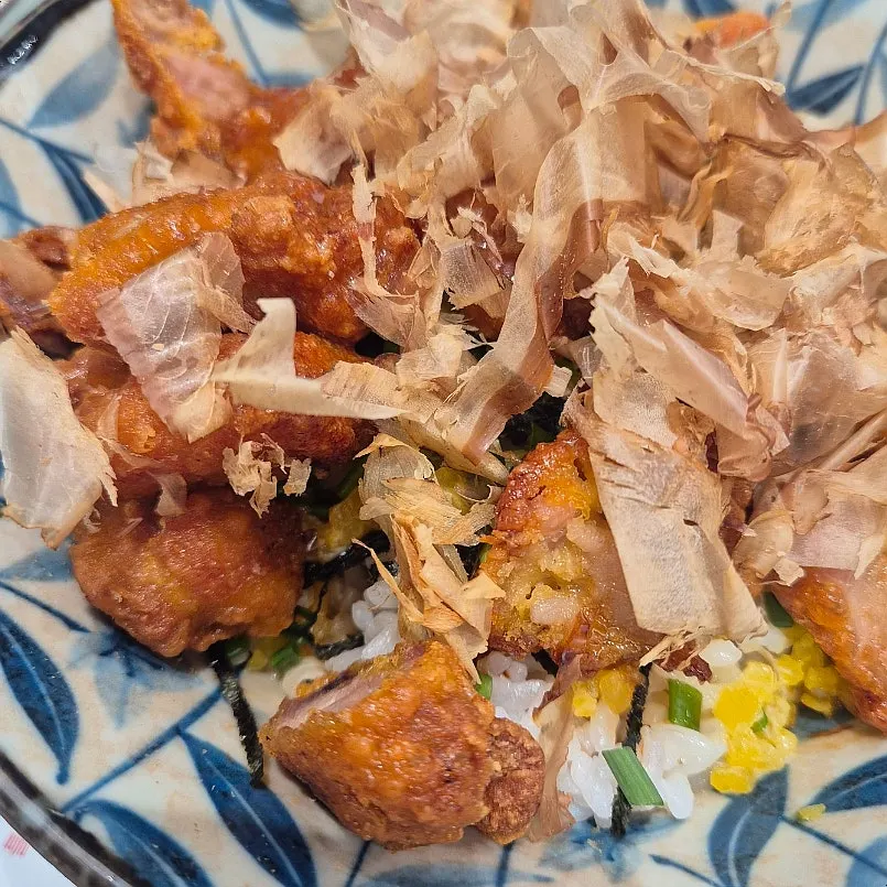 Close-up of chicken karaage coated in sweet sauce over rice
