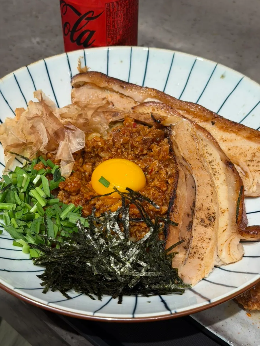 Close-up of the dongpo pork ramen broth and toppings