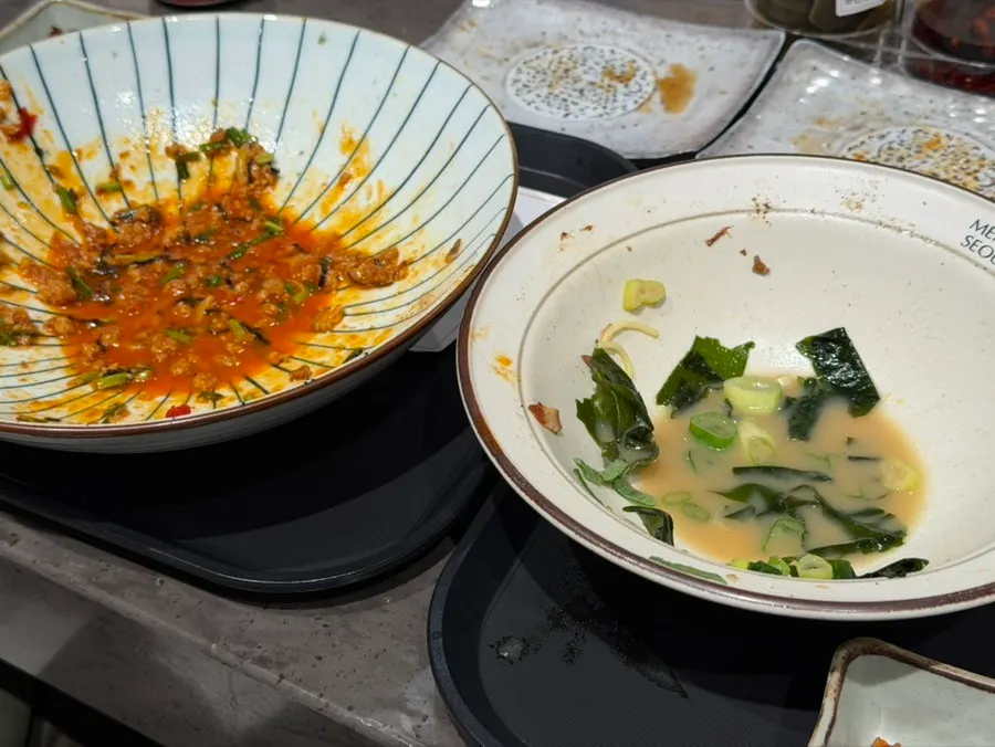 Empty bowls of ramen and mazesoba finished by the couple