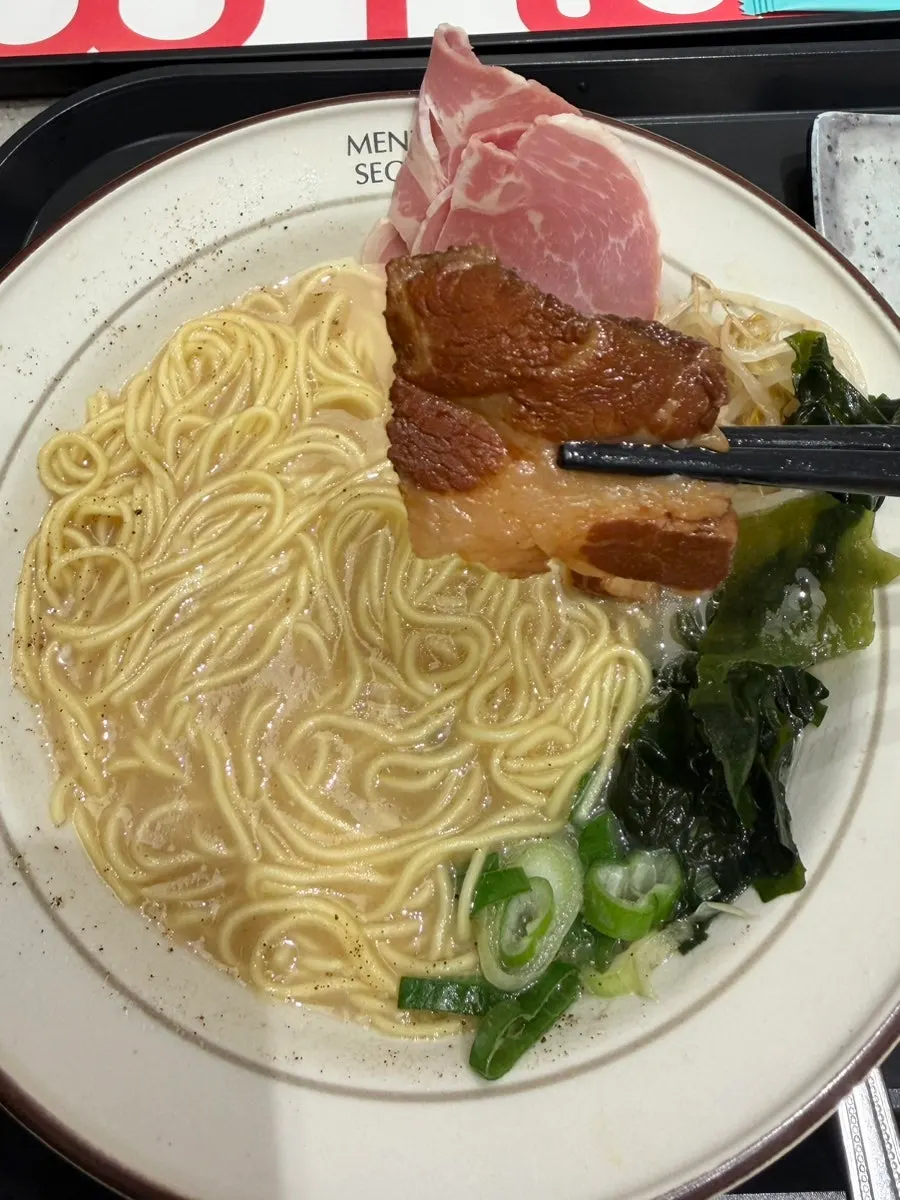A bowl of ramen with rich broth