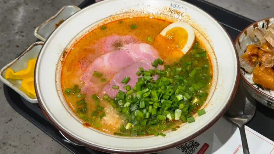 Spicy jambon char siu ramen topped with thin, wide jambon slices