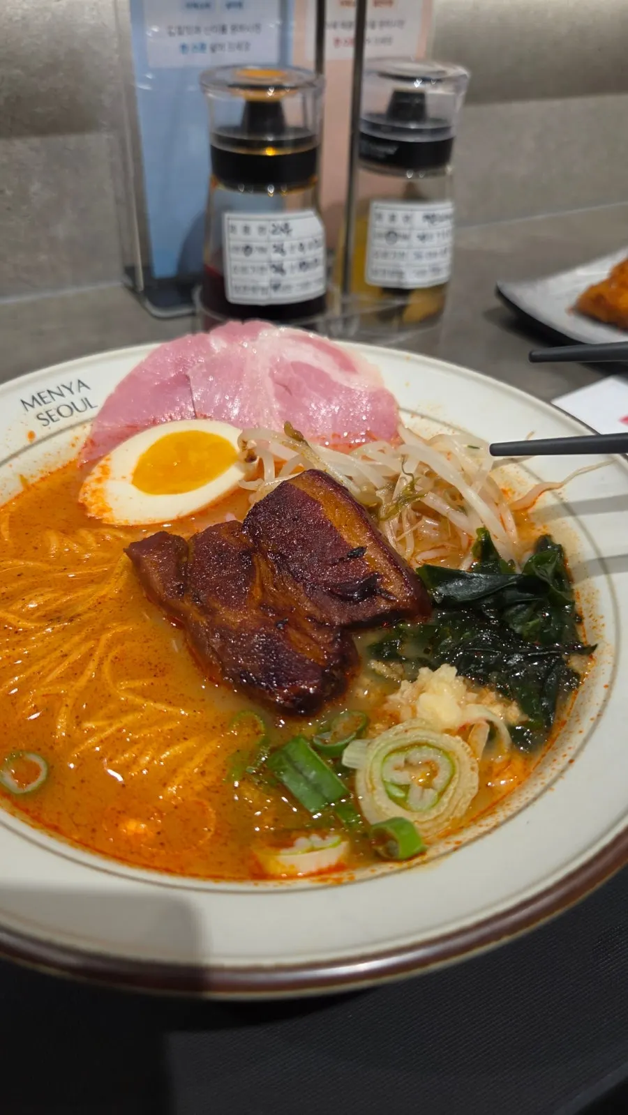 Close-up of the ramen showing thick dongpo pork and noodles