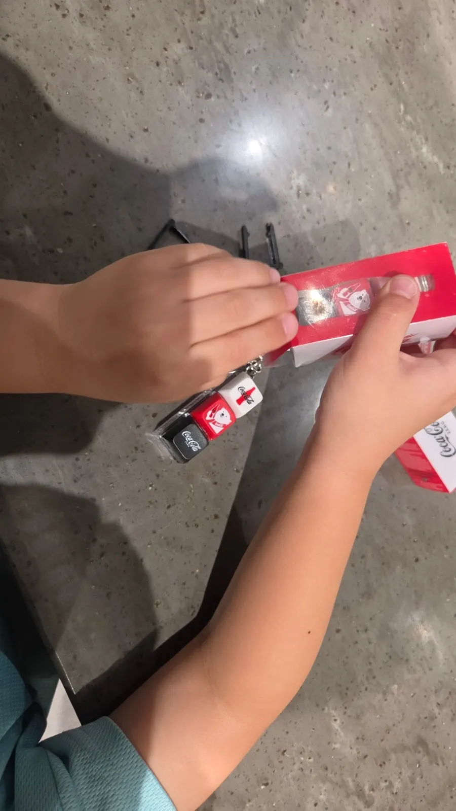 Two Coca-Cola keycaps with a cola