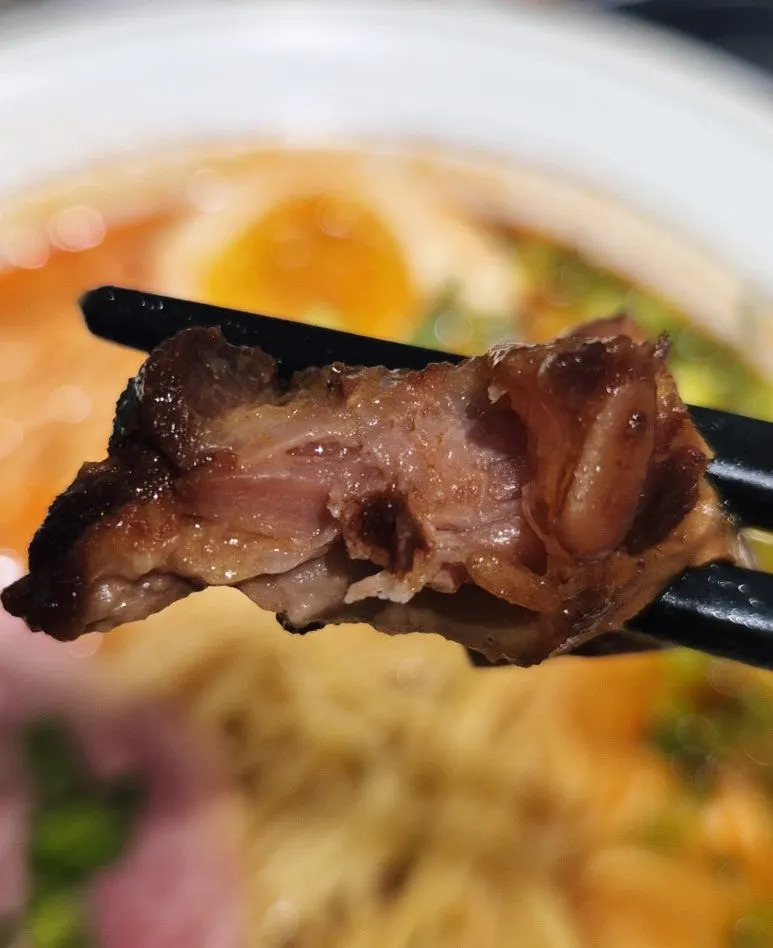 Adding chili oil to the mild-broth ramen
