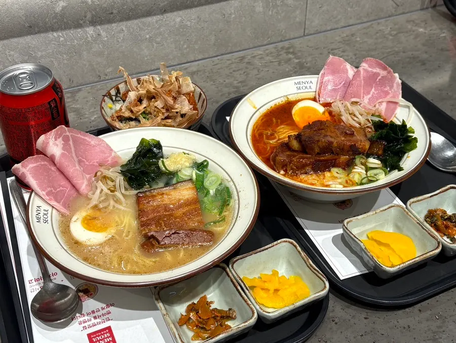 Two bowls of ramen topped with jambon and dongpo pork