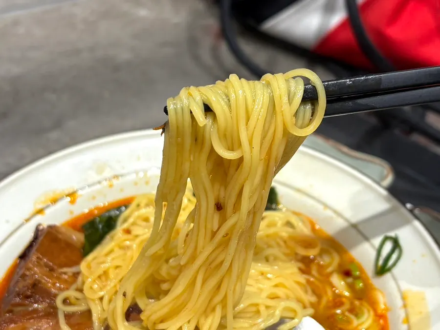 Dongpo pork and cilantro topping on the mala broth ramen
