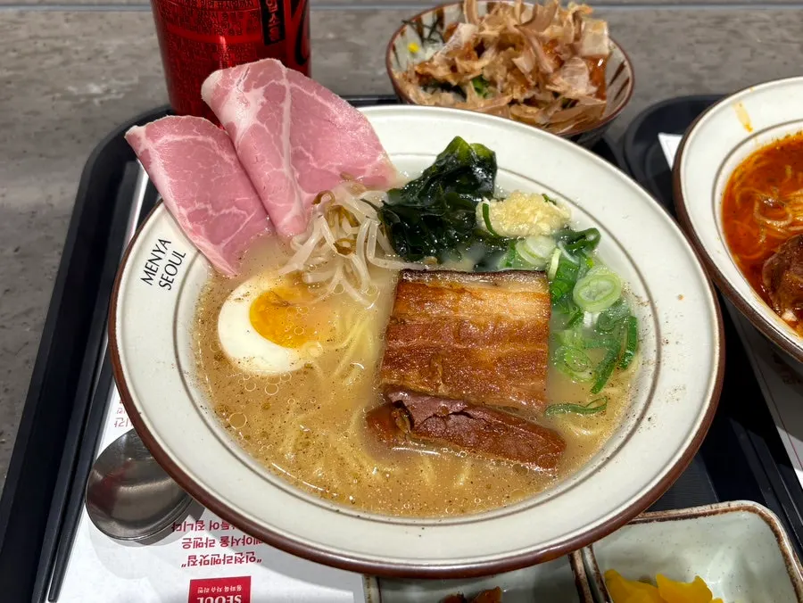 Noodles lifted up from the mala broth ramen