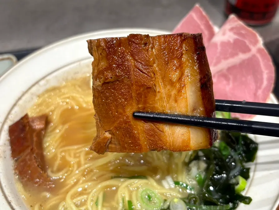 Ramen noodles lifted with chopsticks