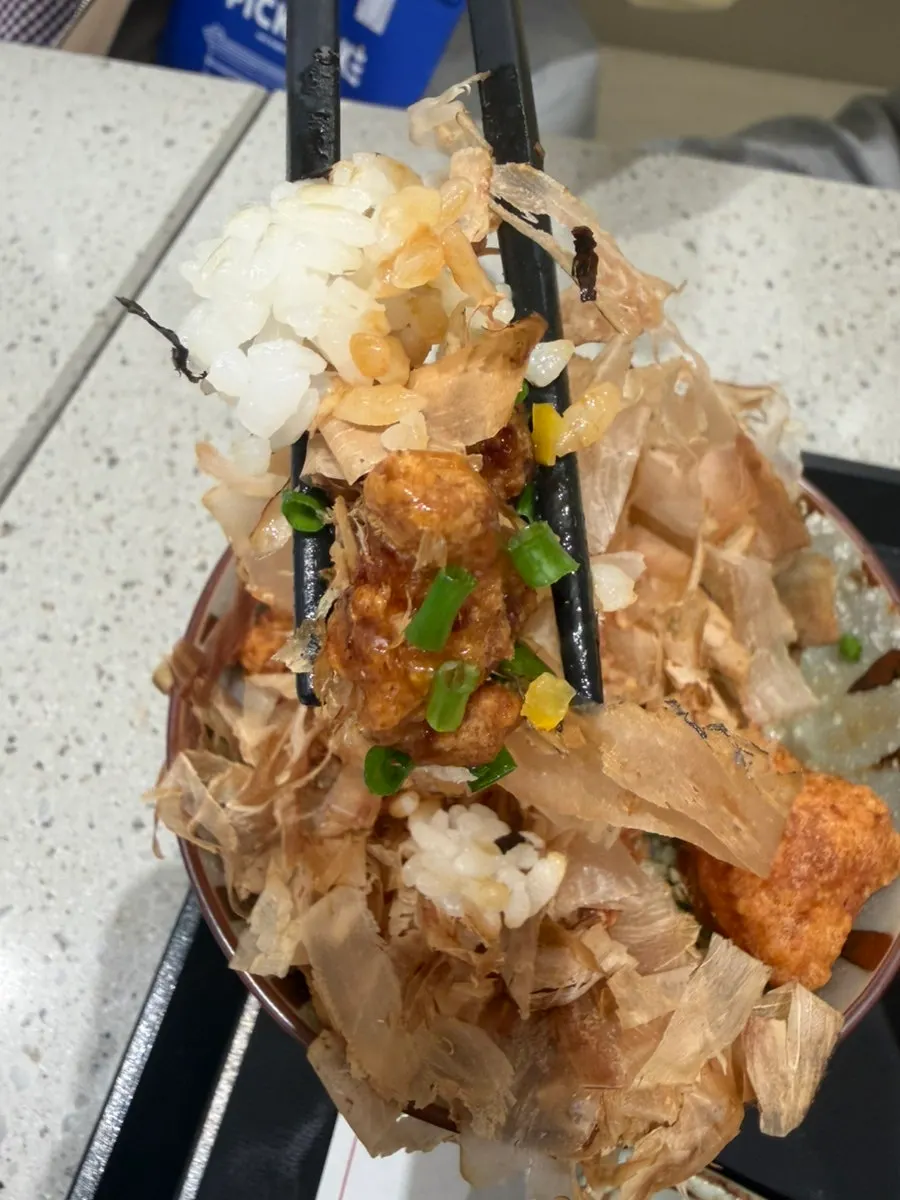Table with ramen and chicken rice bowl together